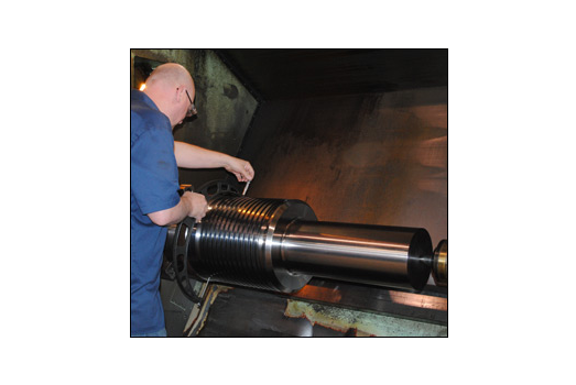 Man working with large metal machine