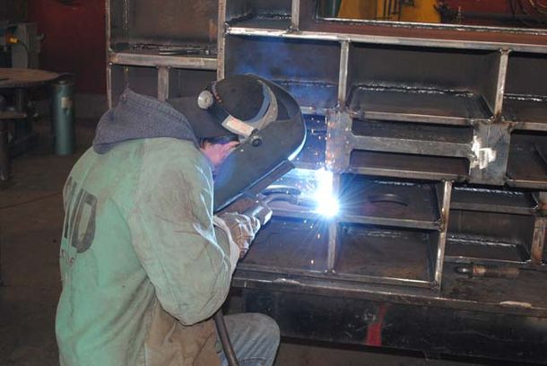 Man welding large table